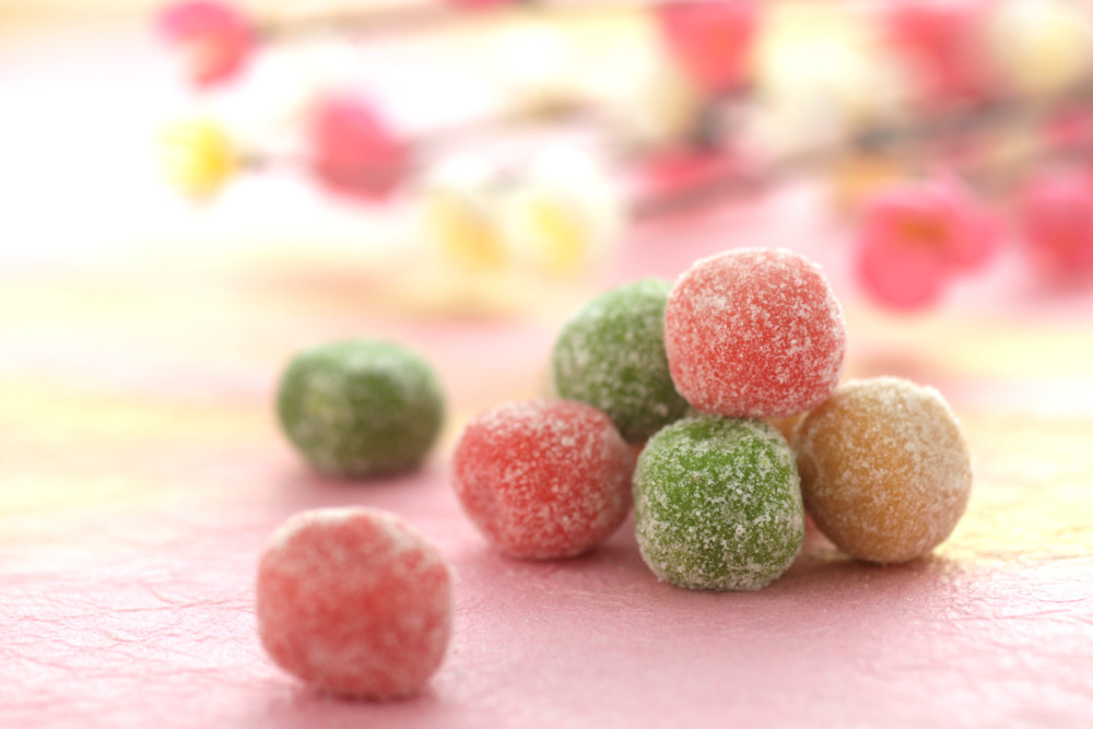 Traditional Japanese wagashi sweets with colorful sugar coating, symbolizing cultural adaptation and international market expansion.