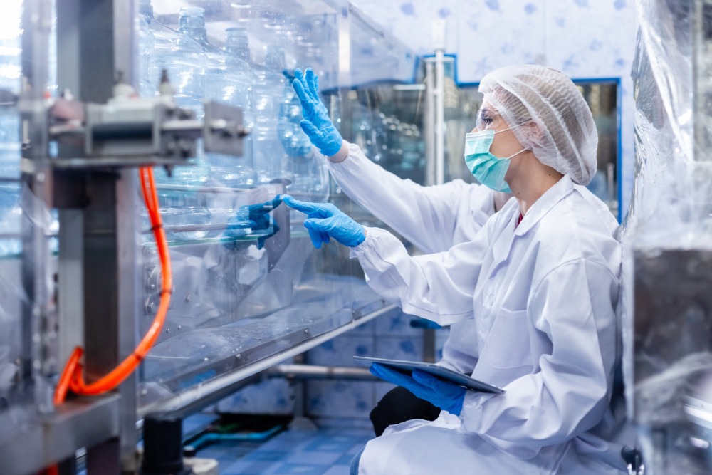 Medical device manufacturing inspection with staff in protective clothing and masks, representing global market entry regulations and quality standards.