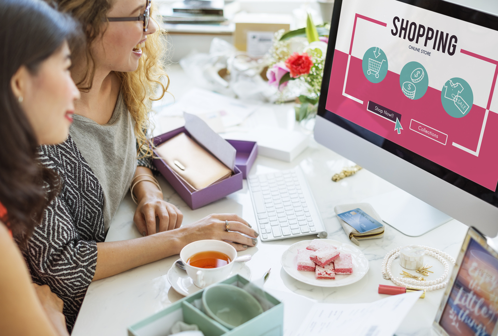 Women shopping online at a desktop computer, representing multilingual website strategies and English support for cross-border e-commerce