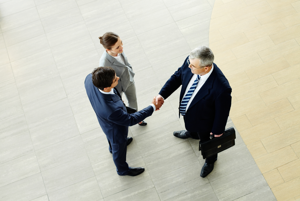 Business professionals shaking hands and building partnerships